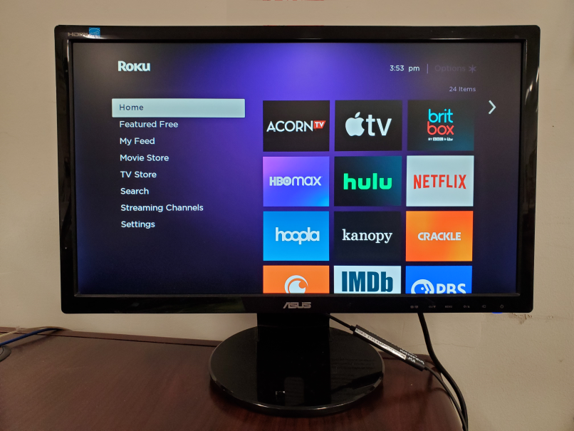 Photo of a desktop monitor with the Roku home screen on it