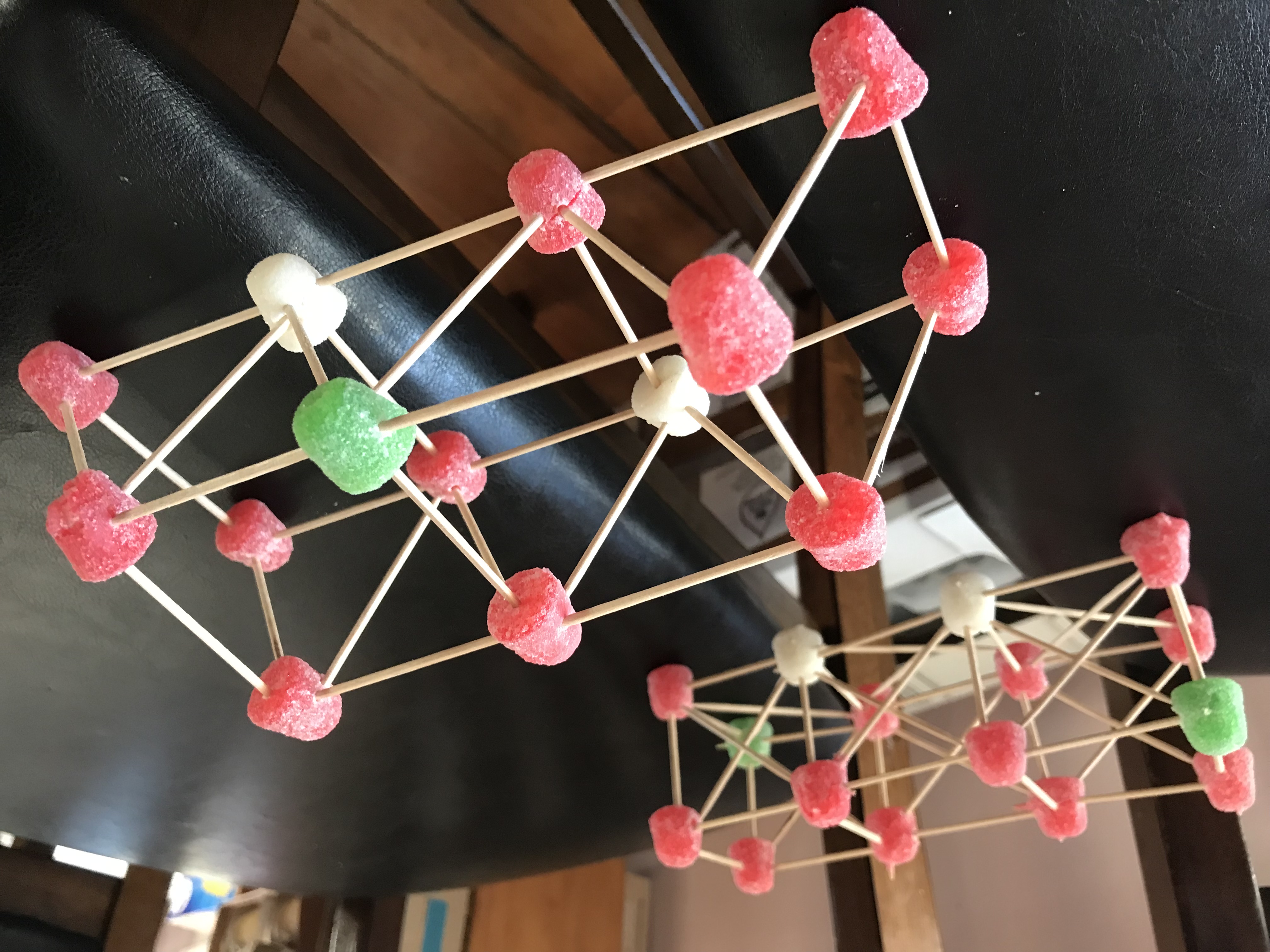 Two truss bridges made of gumdrops and toothpicks.