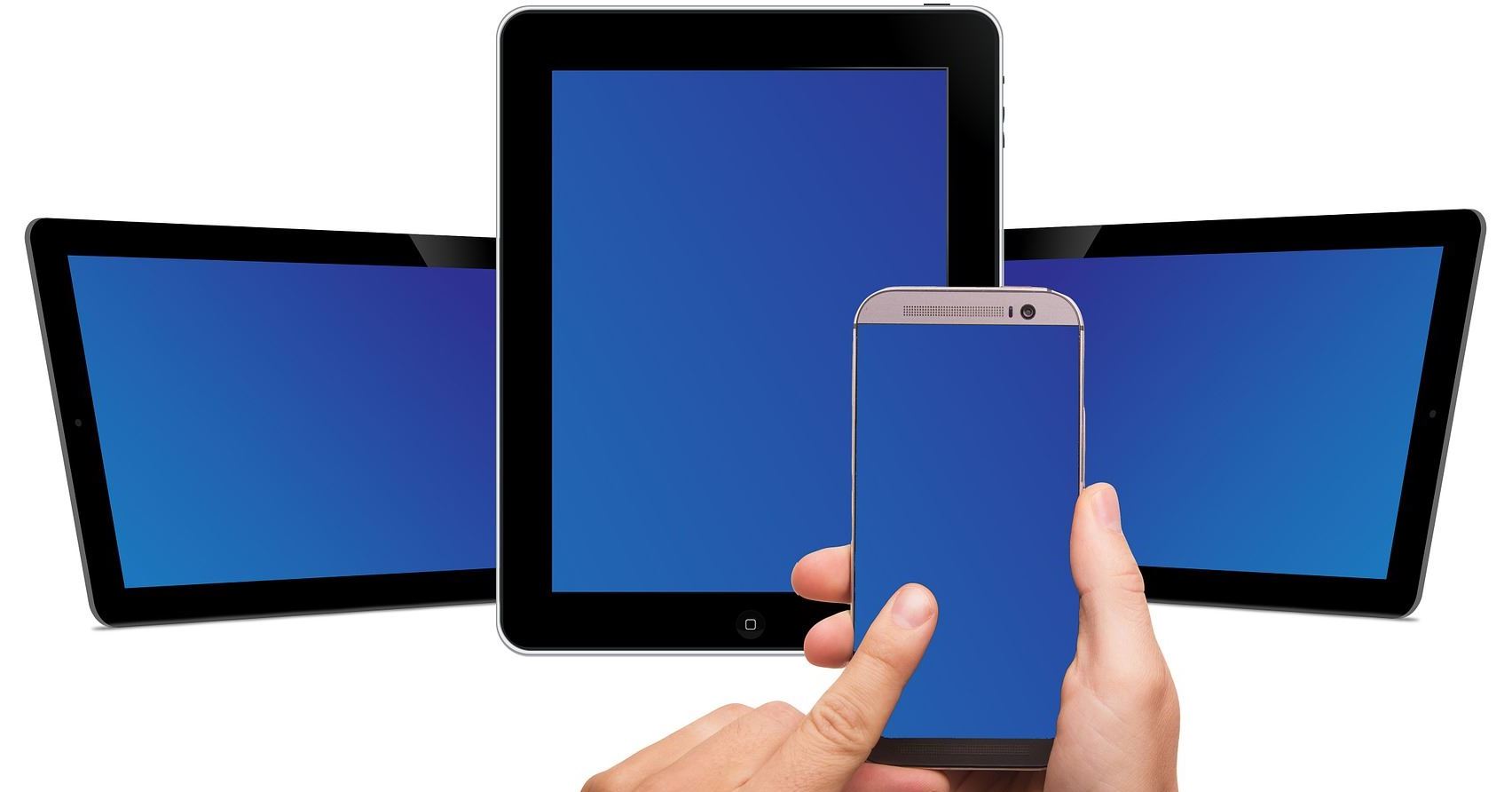 Three tablet computers behind hands holding a smartphone