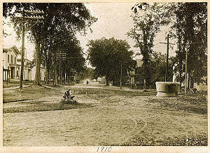 1910 photograph of Main Street in Williamsburg, Mass. looking northwest. Trolley tracks and watering trough are shown.