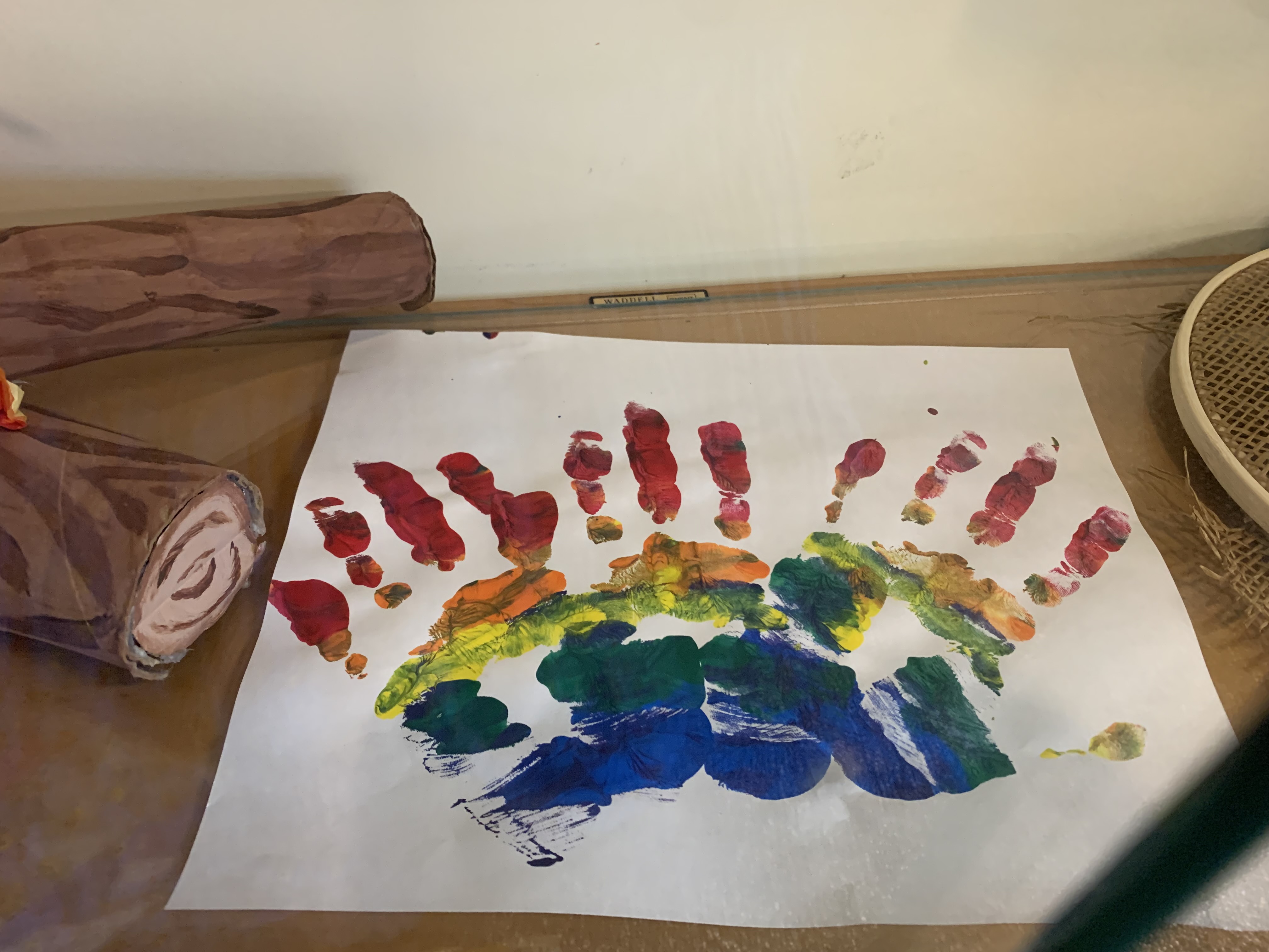 handprints in rainbow paint