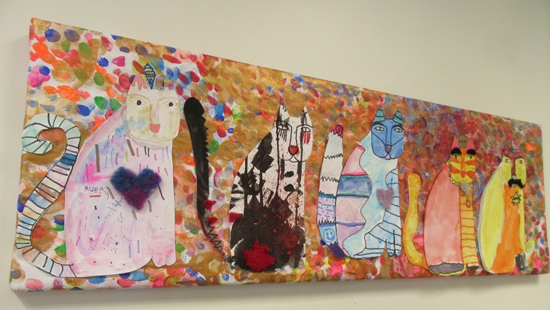 photo of colorful artwork featuring cats done by students at K.A. Brett School