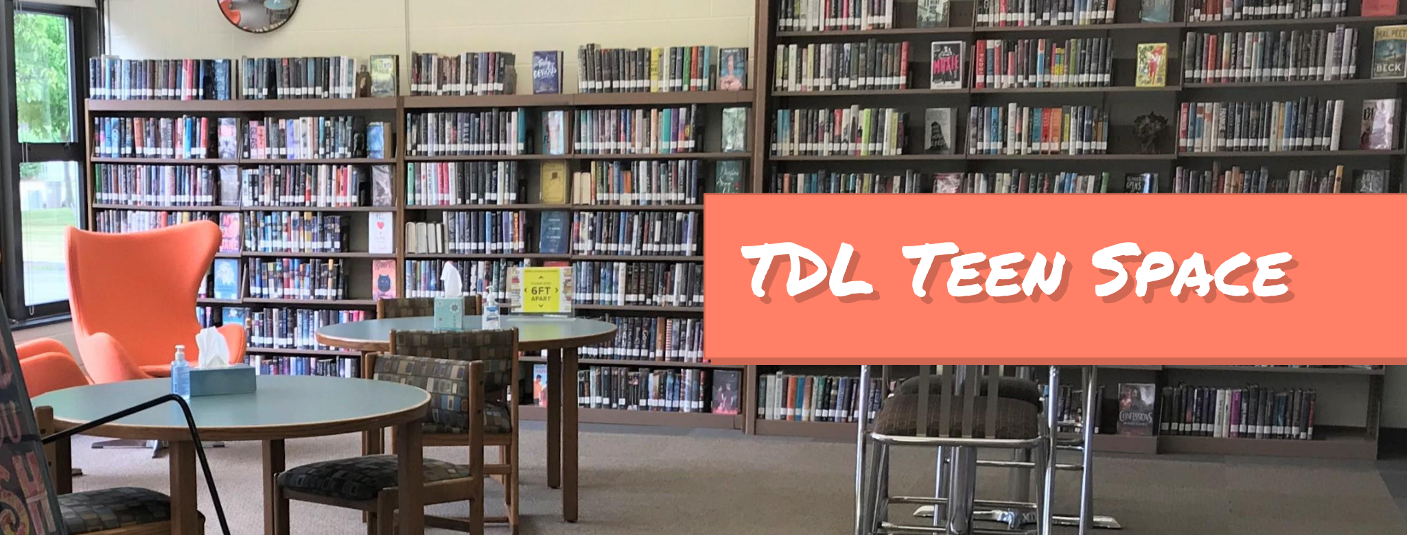 Photo of the bookshelves, chairs, and tables in the teen section with the text TDL Teen Space on an orange banner