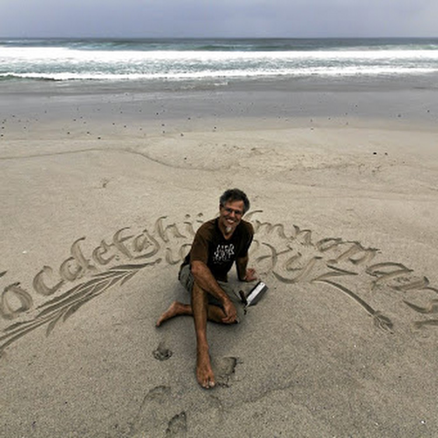 Picture of Andrew Van Der Merwe and beach calligraphy