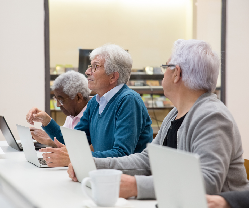 Older adults sitting in front of computers