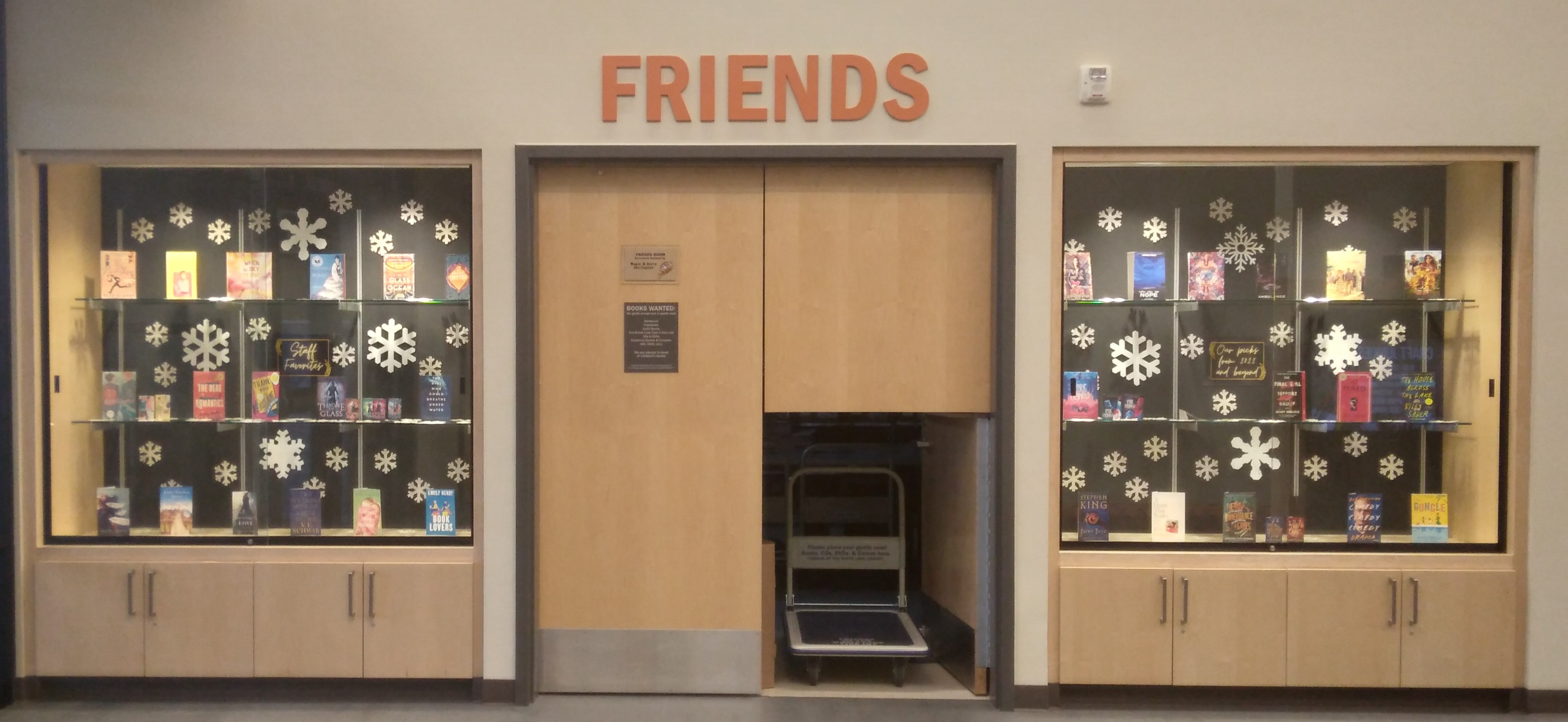 Image of Friends Room door with book cart visible and displays on each side